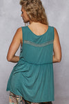 Back view of a woman wearing the Evergreen Meadow Top against a grey background.