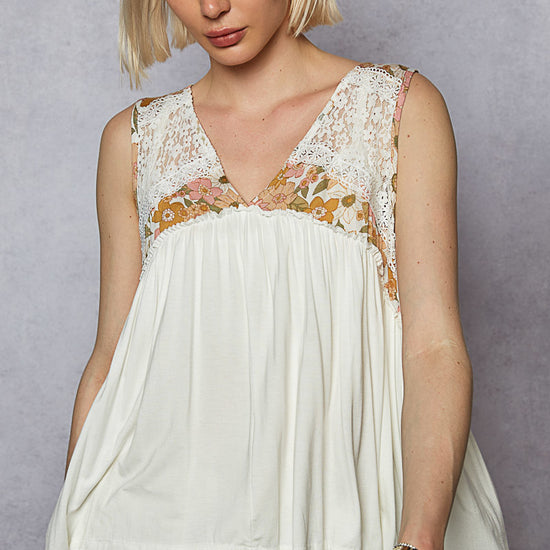 Woman wearing the Juniper Bloom Top with a blank background.