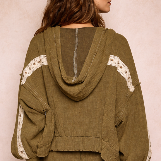 back view of woman wearing an olive boho jacket with crochet detail and relaxed fit on a neutral beige background, lightweight boutique jacket styled for casual everyday outfits