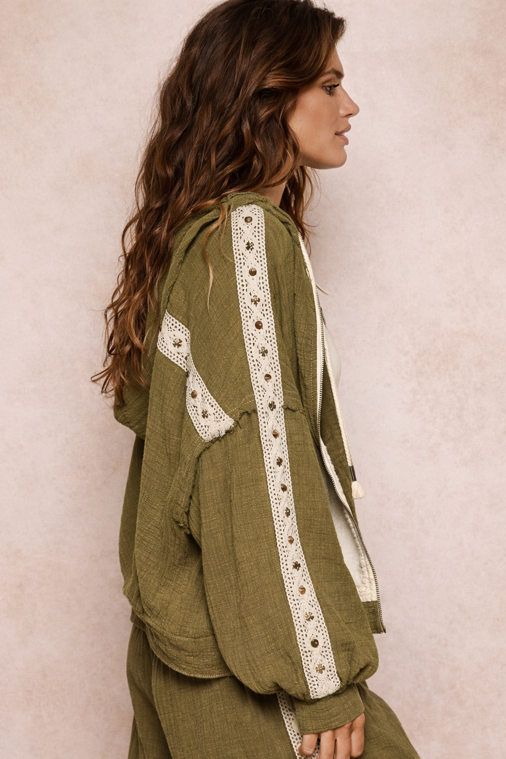 side view of woman wearing an olive boho jacket with crochet detail and relaxed fit on a neutral background, lightweight boutique jacket styled for casual everyday outfits