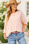 The model is wearing the Peach Oversized Dolman Sleeve Top and a straw hat.