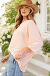 Side view of a model wearing the Peach Oversized Dolman Sleeve Top.