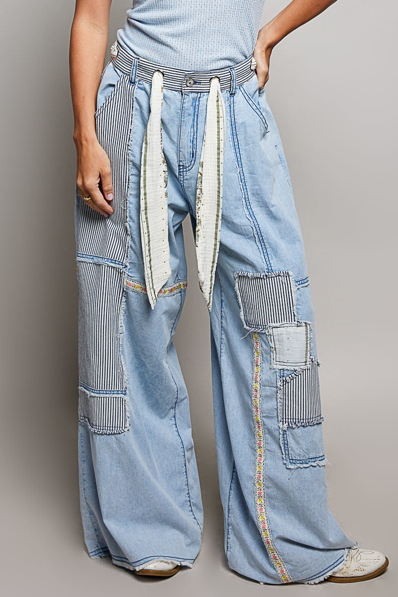 Woman wearing POL Clothing Wide Leg Patchwork jeans with a grey background.