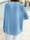 Back view of a soft blue textured jacquard shift top with relaxed fit and long sleeves styled with white jeans for an everyday casual look