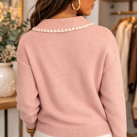 Back view of blush pink knit sweater with sweetheart collar detailed styled with light neutral bottoms.