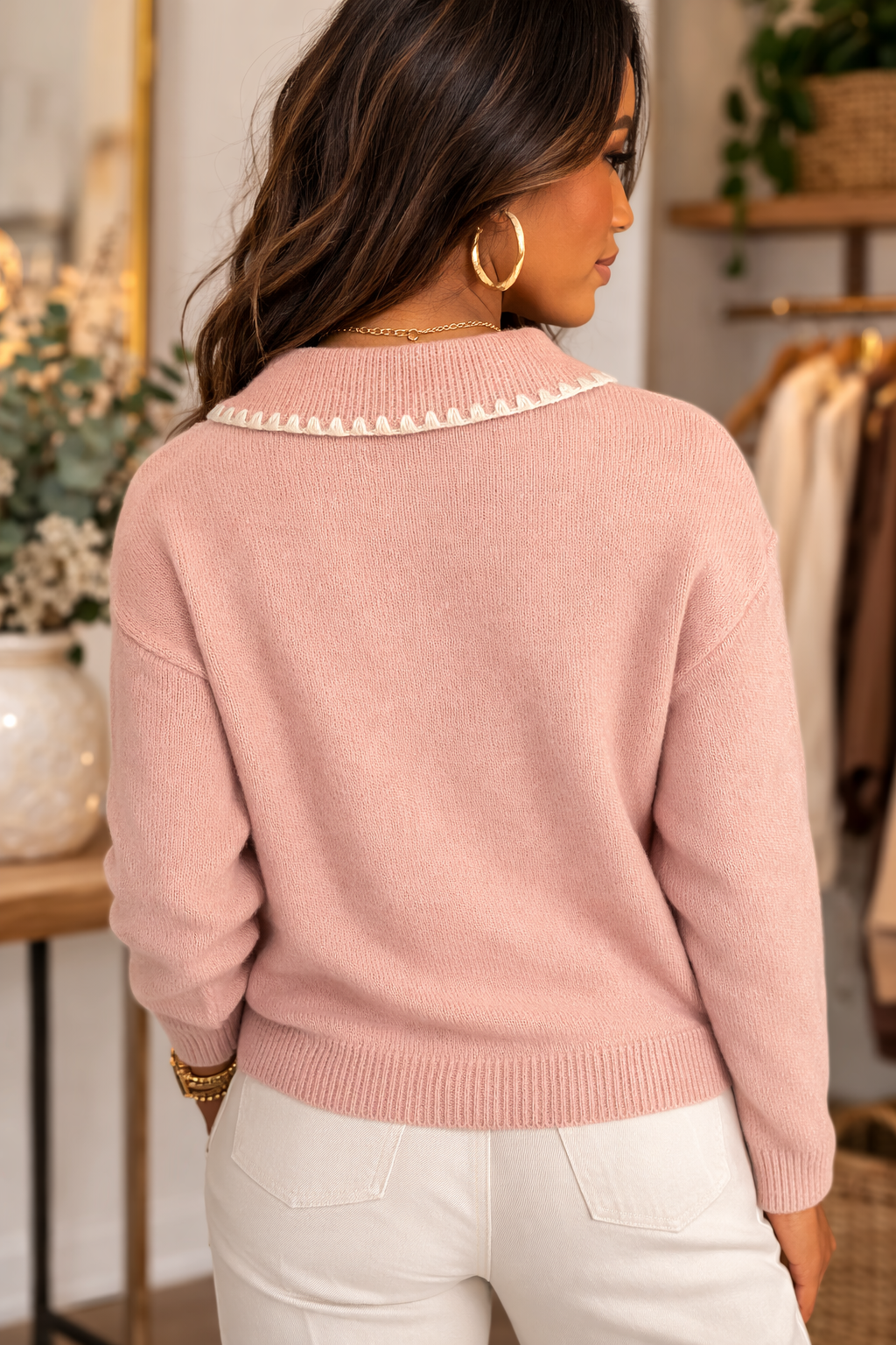 Back view of blush pink knit sweater with sweetheart collar detailed styled with light neutral bottoms.