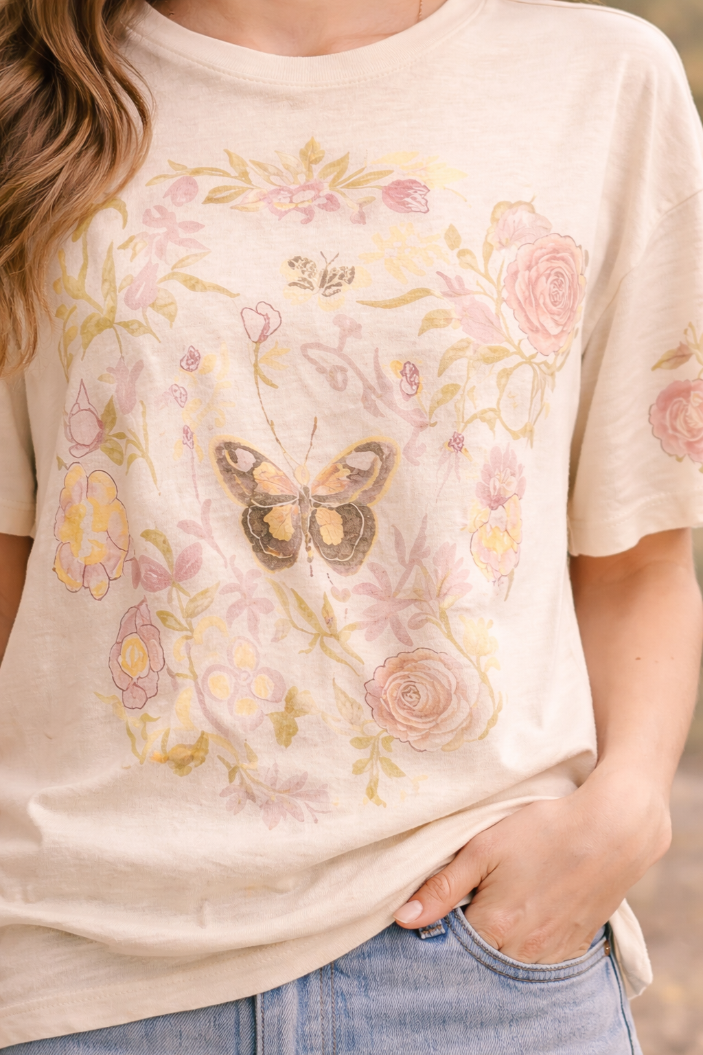 Close-up of women's butterfly floral graphic tee featuring vintage botanical butterfly design