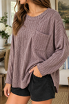 Close-up of women's heathered plum ribbed knit pocket top showing chest pocket, round neckline and textured knit