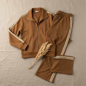 Caramel Stripe Tracksuit Set flat lay featuring matching track jacket and wide leg pants on a warm neutral linen background