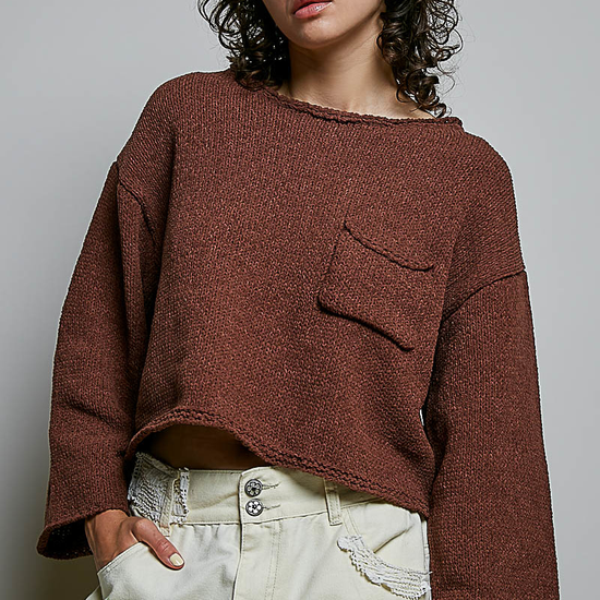 Model wearing POL Clothing brown cropped open-knit sweater with rolled neckline and chest pocket