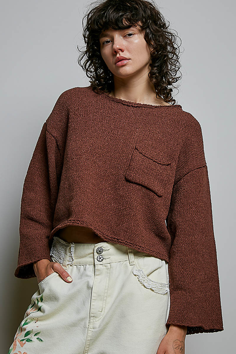 Model wearing POL Clothing brown cropped open-knit sweater with rolled neckline and chest pocket