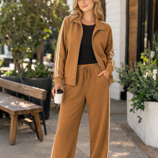 Model wearing the Caramel Stripe Tracksuit Set in a warm outdoor setting