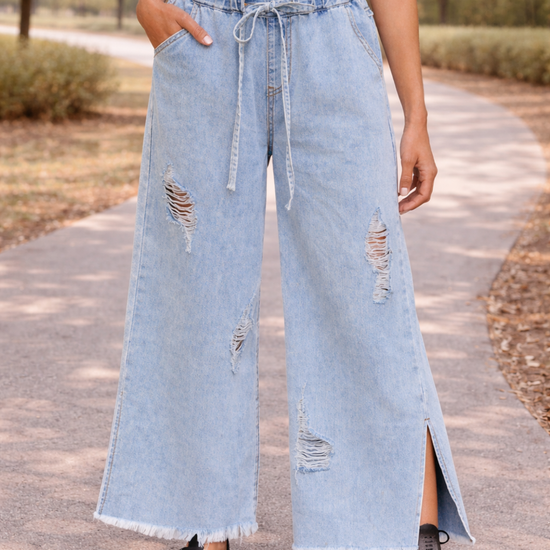Light wash distressed wide leg jeans with paper bag waist and drawstring detail
