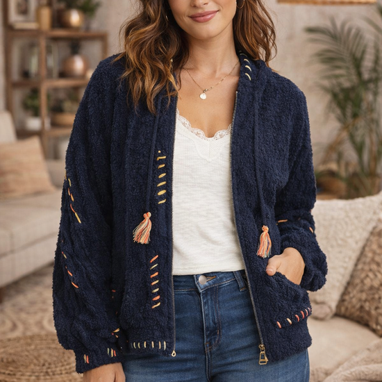 Navy boho textured cozy zip jacket with artisan stitching styled with denim in a cozy boho living room.