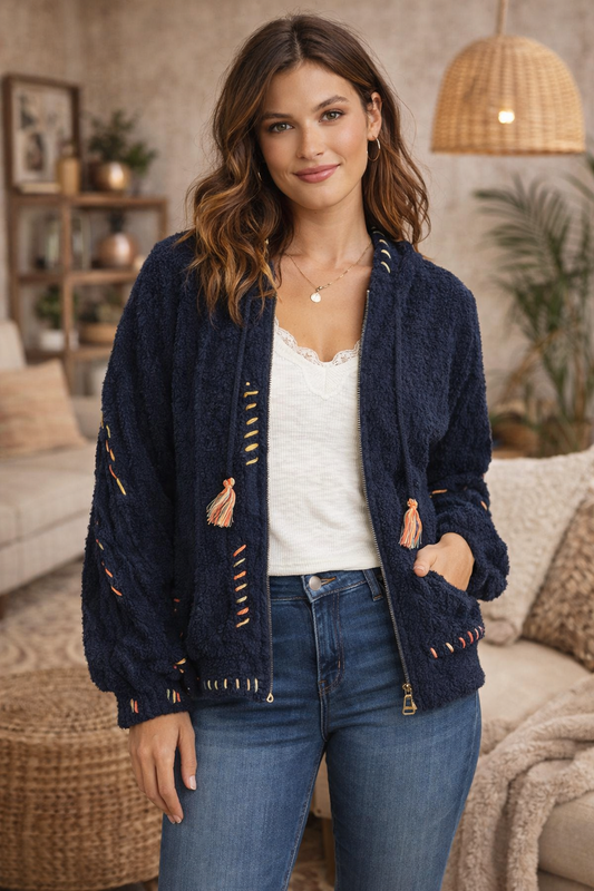 Navy boho textured cozy zip jacket with artisan stitching styled with denim in a cozy boho living room.