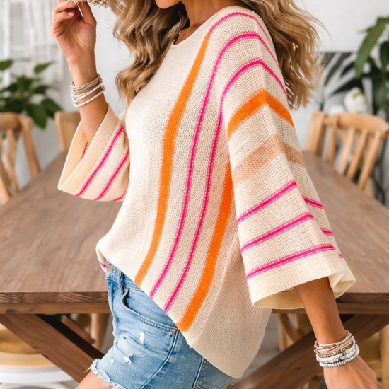 Boho lightweight knit sweater with sunset stripes in pink and orange, wide sleeve relaxed fit shown in side view for everyday casual styling
